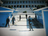 This is a picture of a picture. Heightened security due to the recent nuclear blast prevented us from observing this above scene. In the foreground are the S Korean soldiers in Tae-Kwon-do poses (they maintain this for 8 hours). In the background are the N Koreans. The blue buildings have their N and S Korean sections. This is where the UN treaties are written/exchanged.